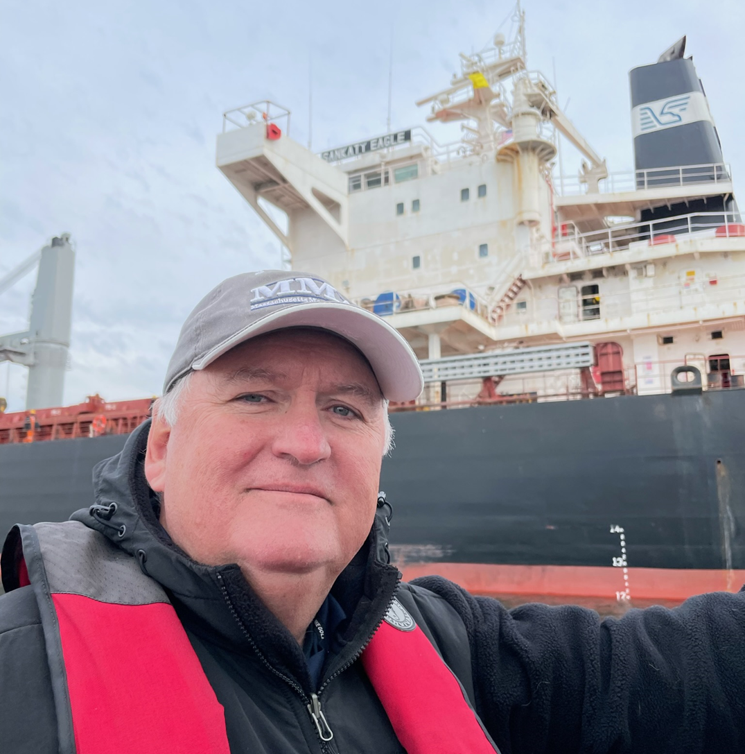 IRI President Bill Gallagher stands in front of a commercial shipping vessel